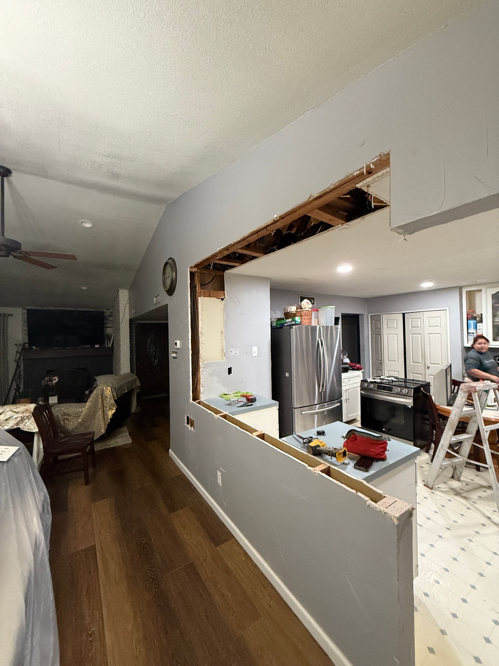 A kitchen is being remodeled with a hole in the wall.