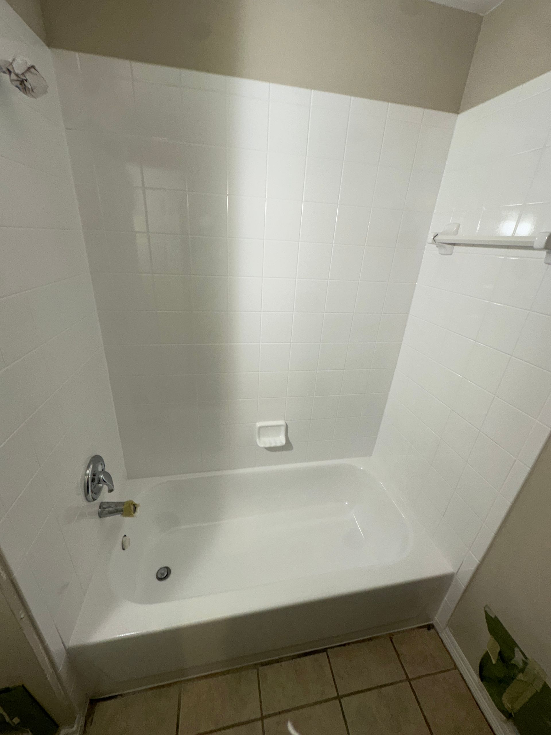 A bathroom with a bathtub and a shower.