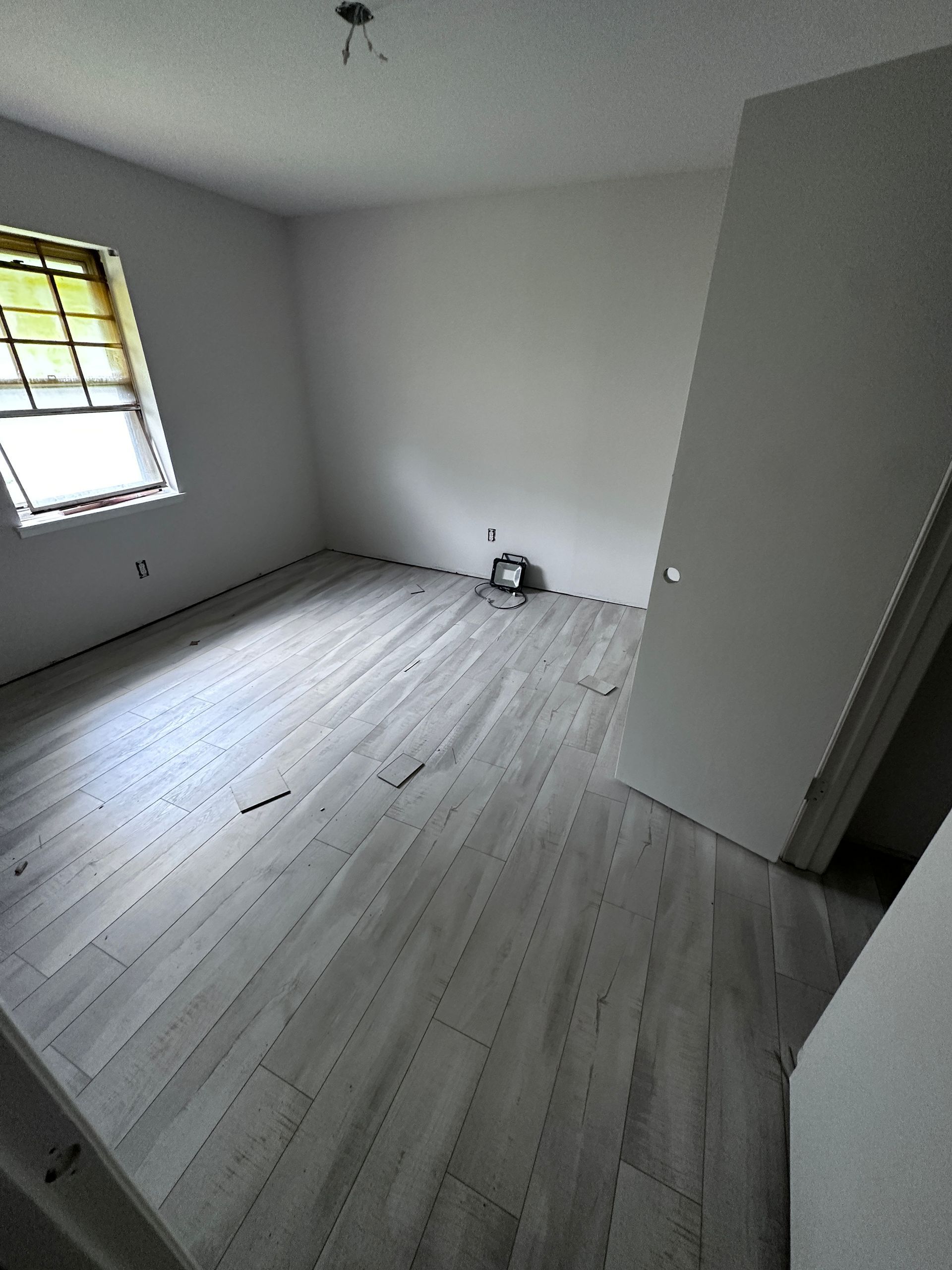 An empty room with a window and a door