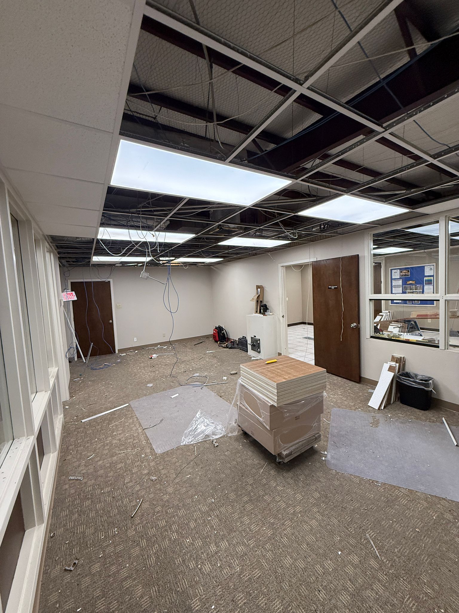 A large empty room with a ceiling that has been damaged.