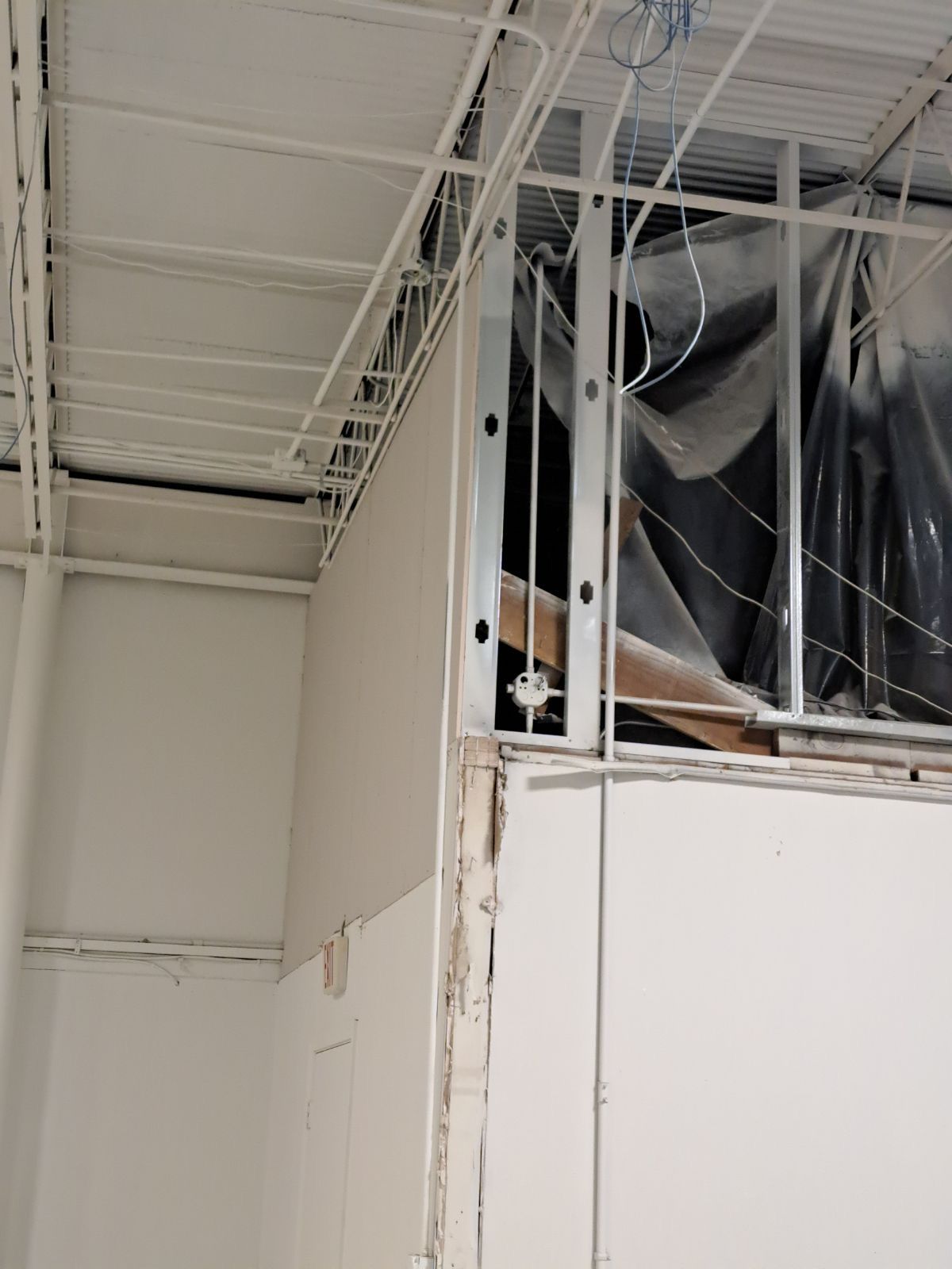 A ceiling with a lot of wires hanging from it