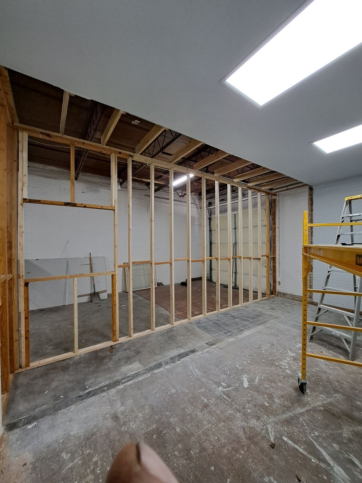 A room with wooden walls and a ladder in it.