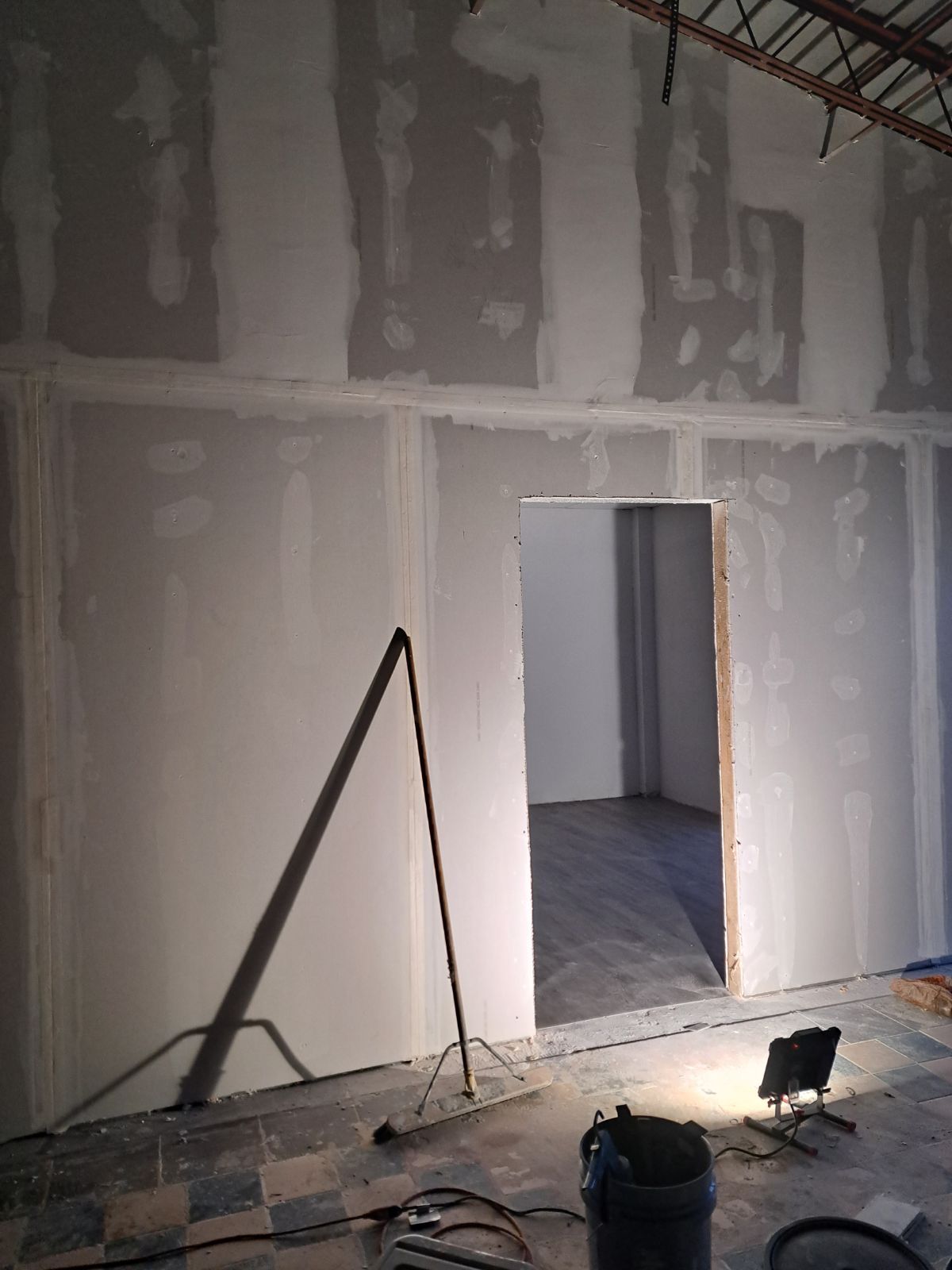 A room with drywall walls and a door in it.