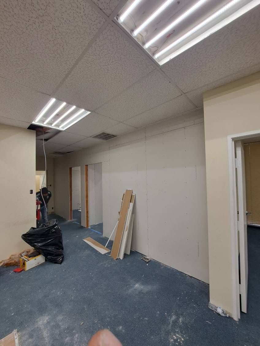 A room with a lot of boxes on the floor and a ceiling light.