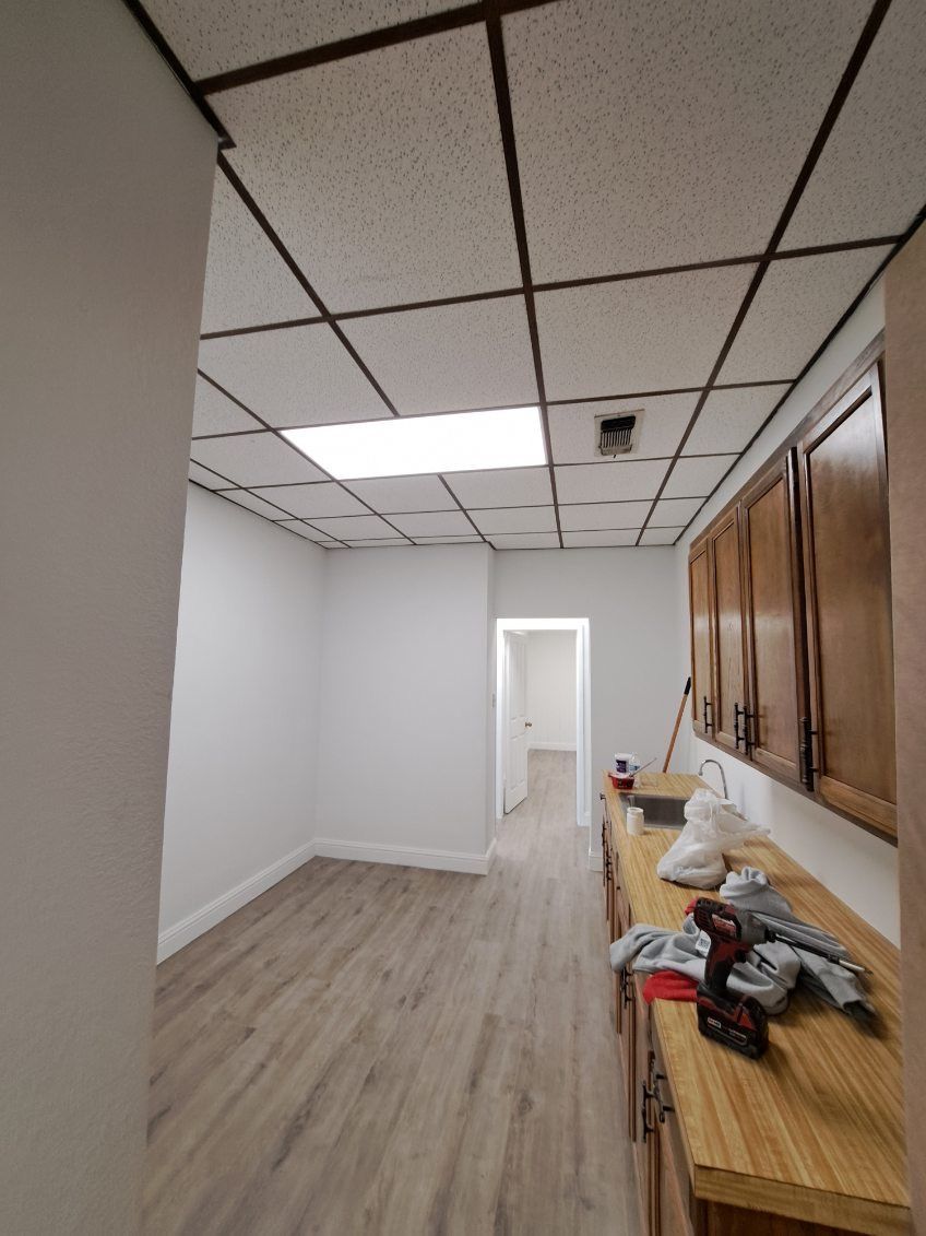 A kitchen with wooden cabinets and a ceiling light