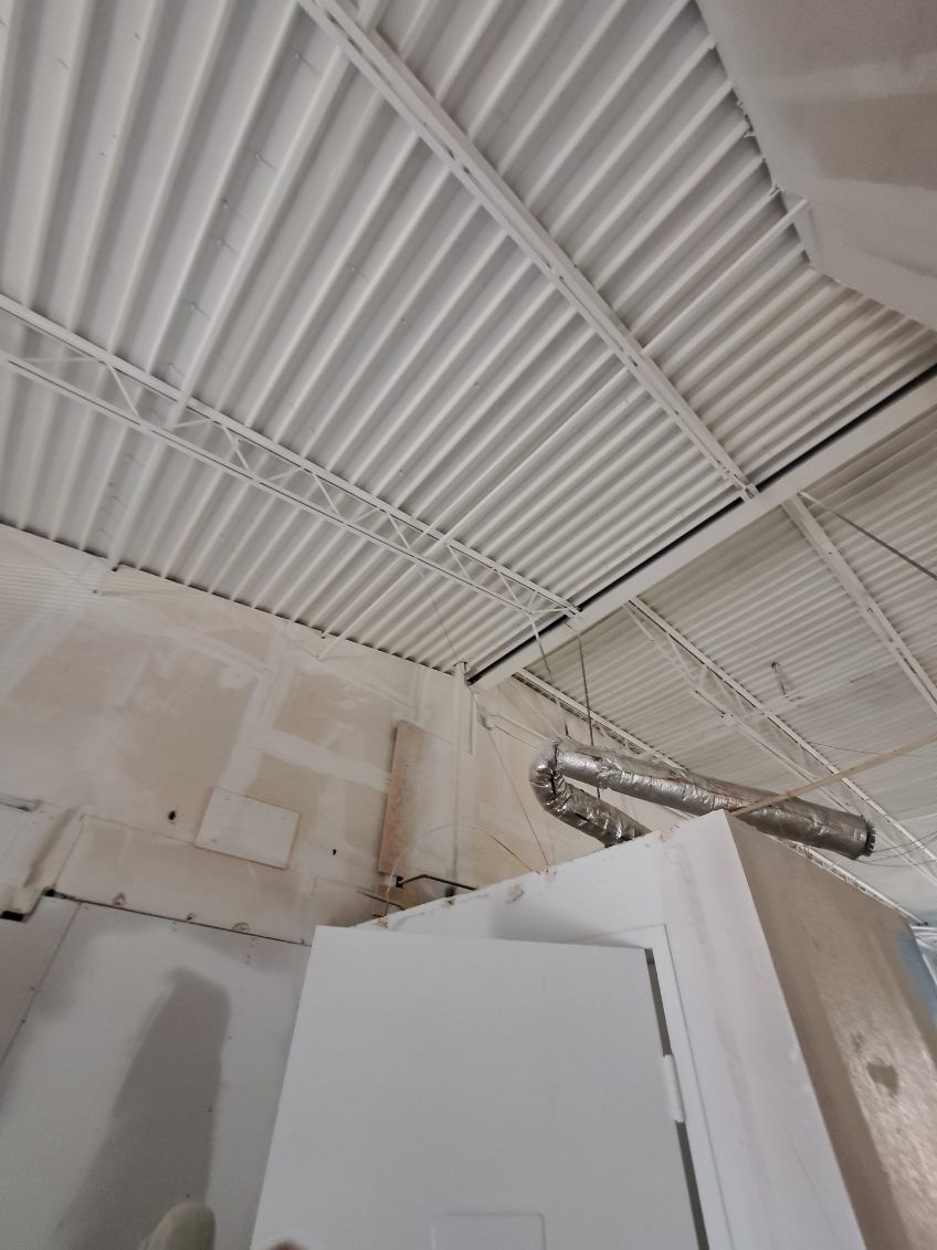 A room with a white ceiling and a white door.