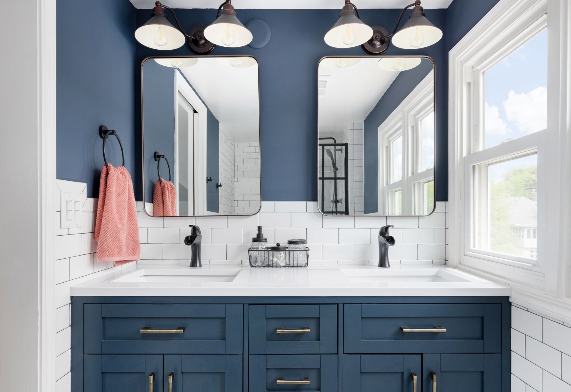 A bathroom with a toilet , sink , mirror and shower.