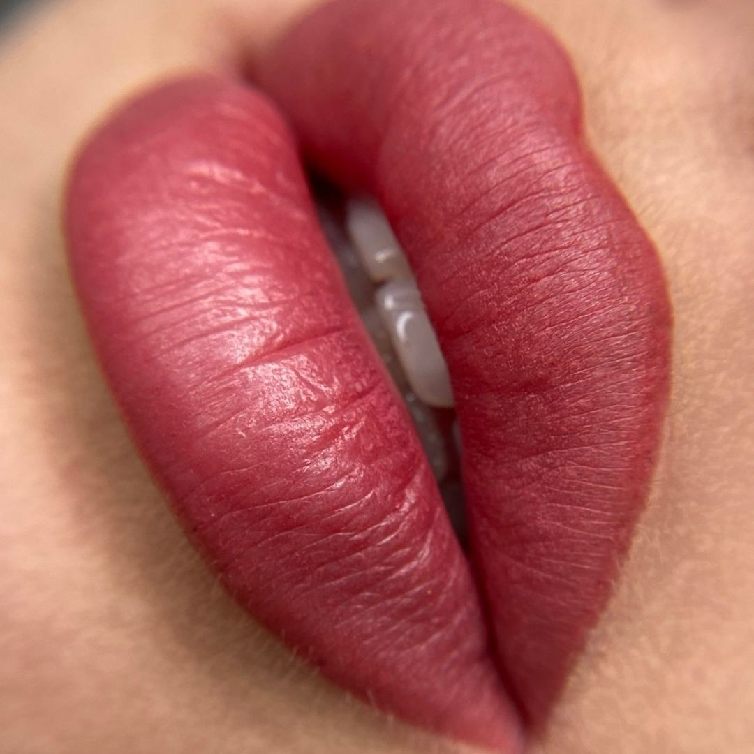 A close up of a woman 's lips with red lipstick.