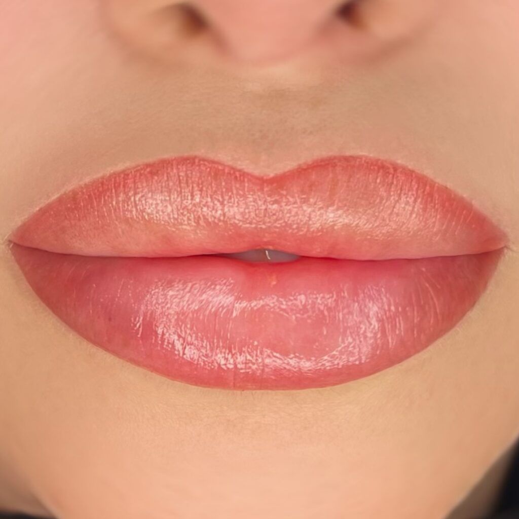 A close up of a woman 's lips with permanent makeup.