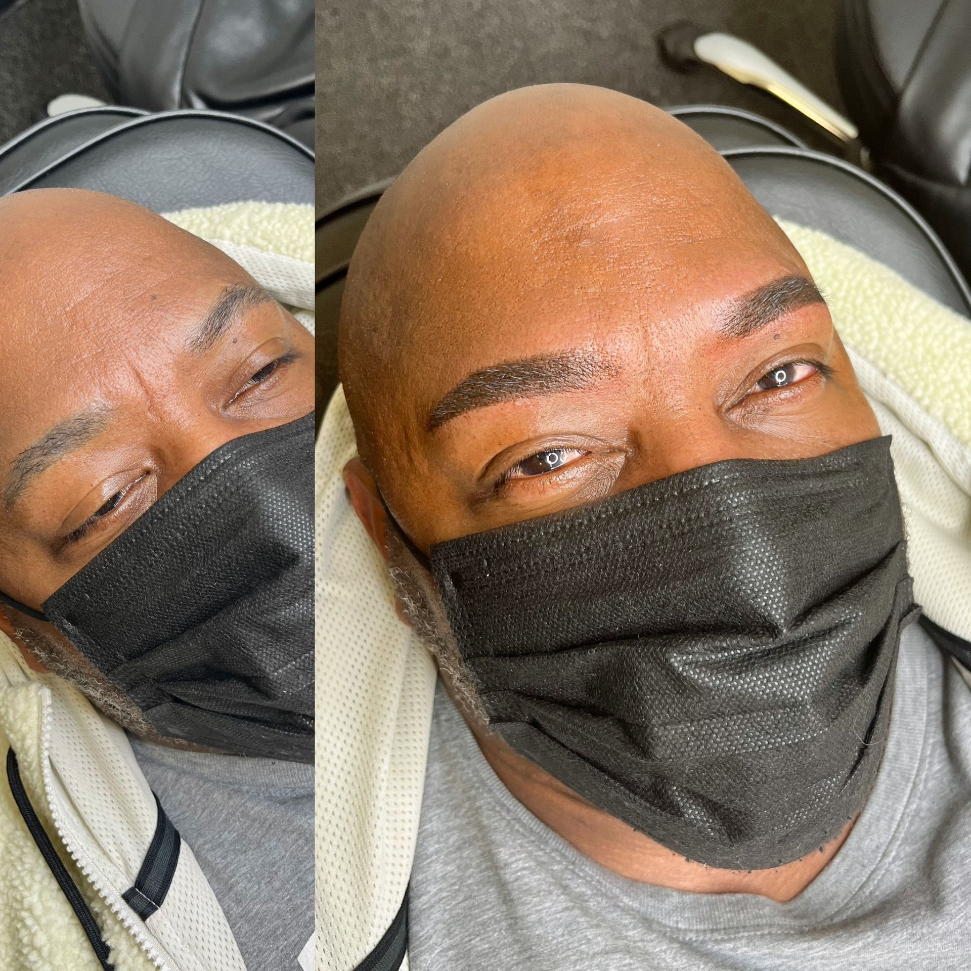 A bald man wearing a black face mask with his eyes closed