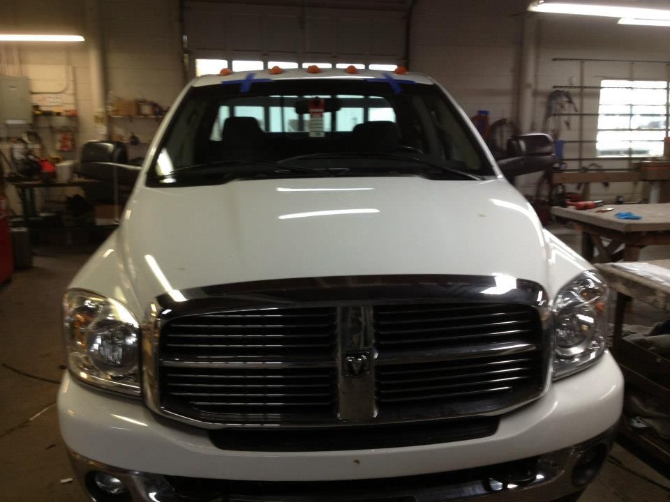 A white dodge truck is parked in a garage