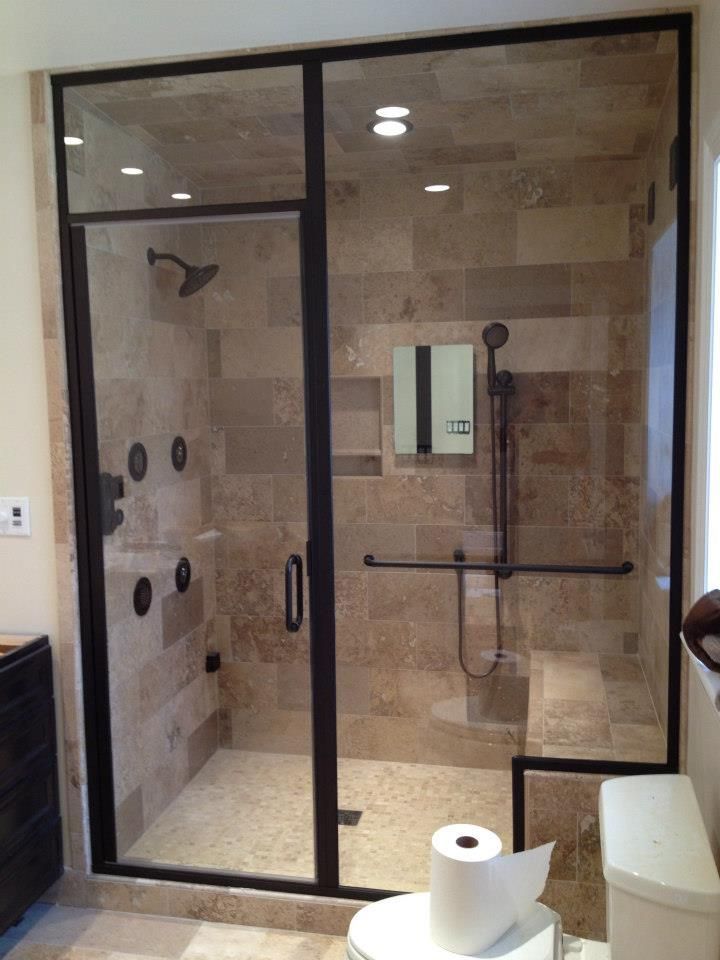 A bathroom with a walk in shower and a toilet.
