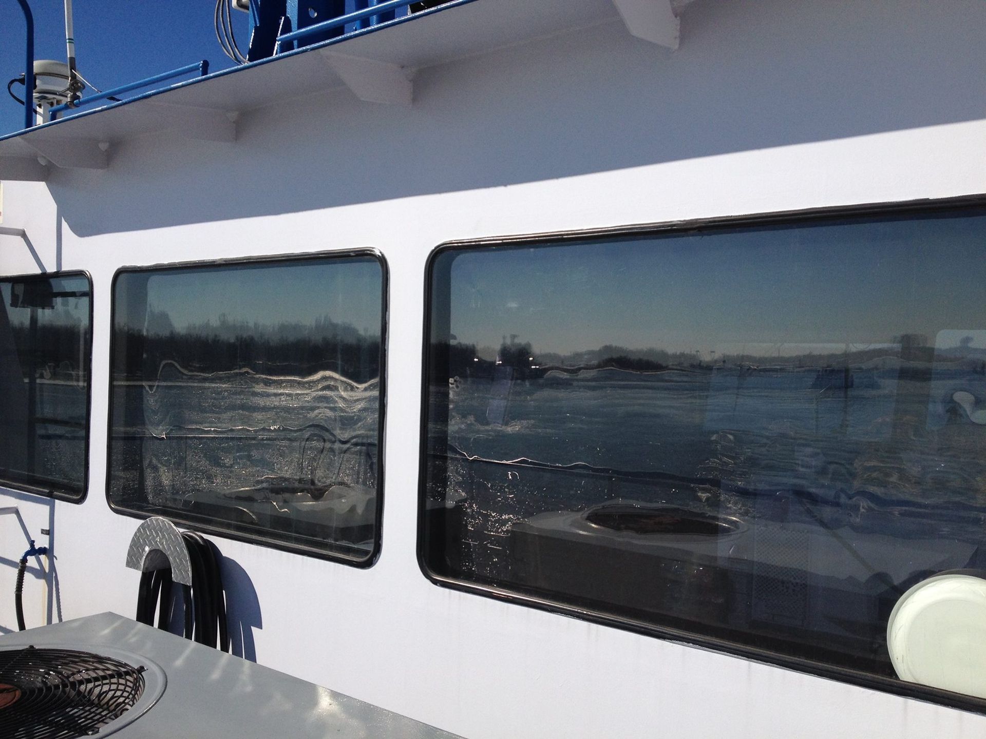A boat with a lot of windows looking out to the water