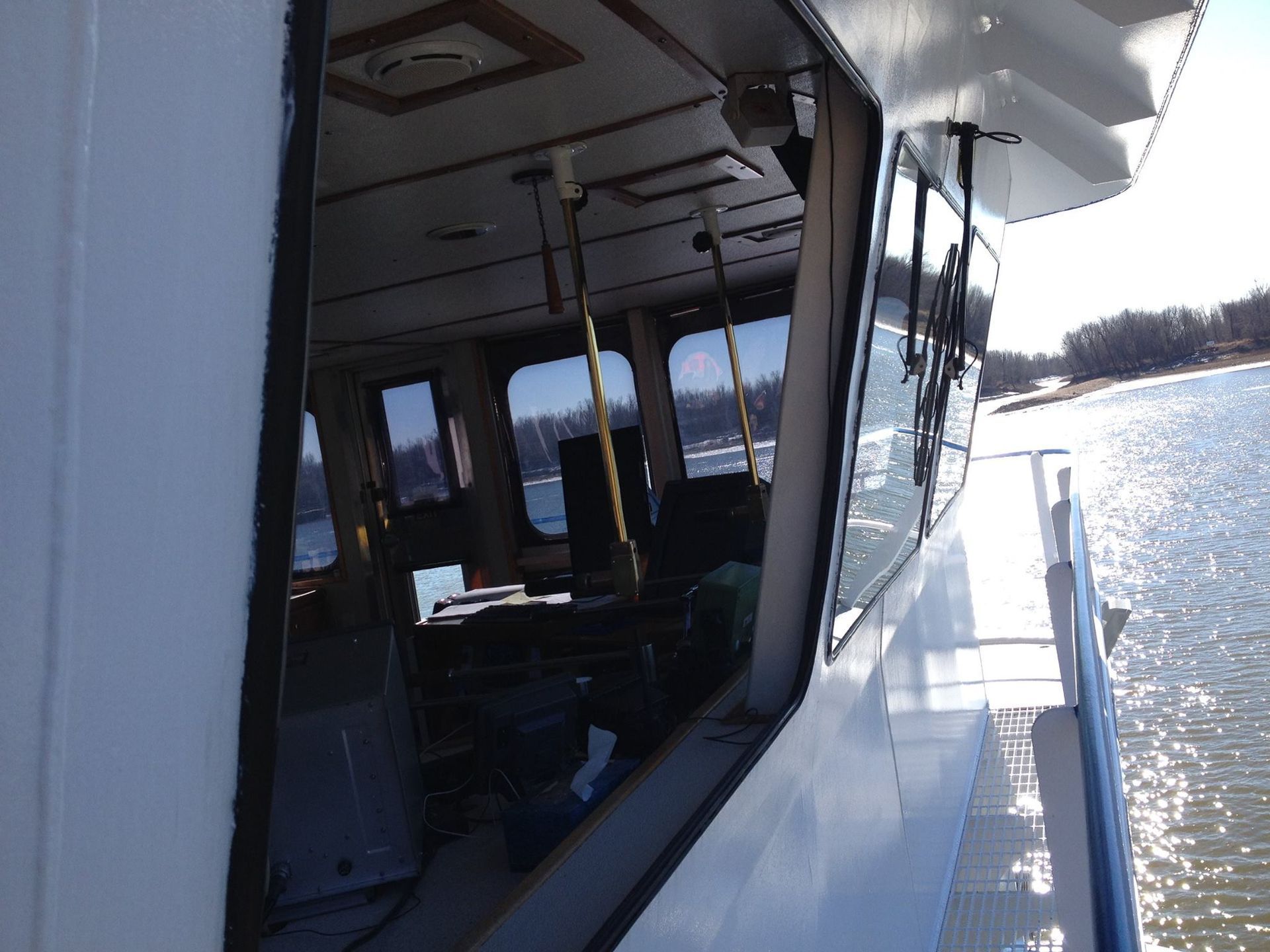 A boat with a lot of windows looking out to the water