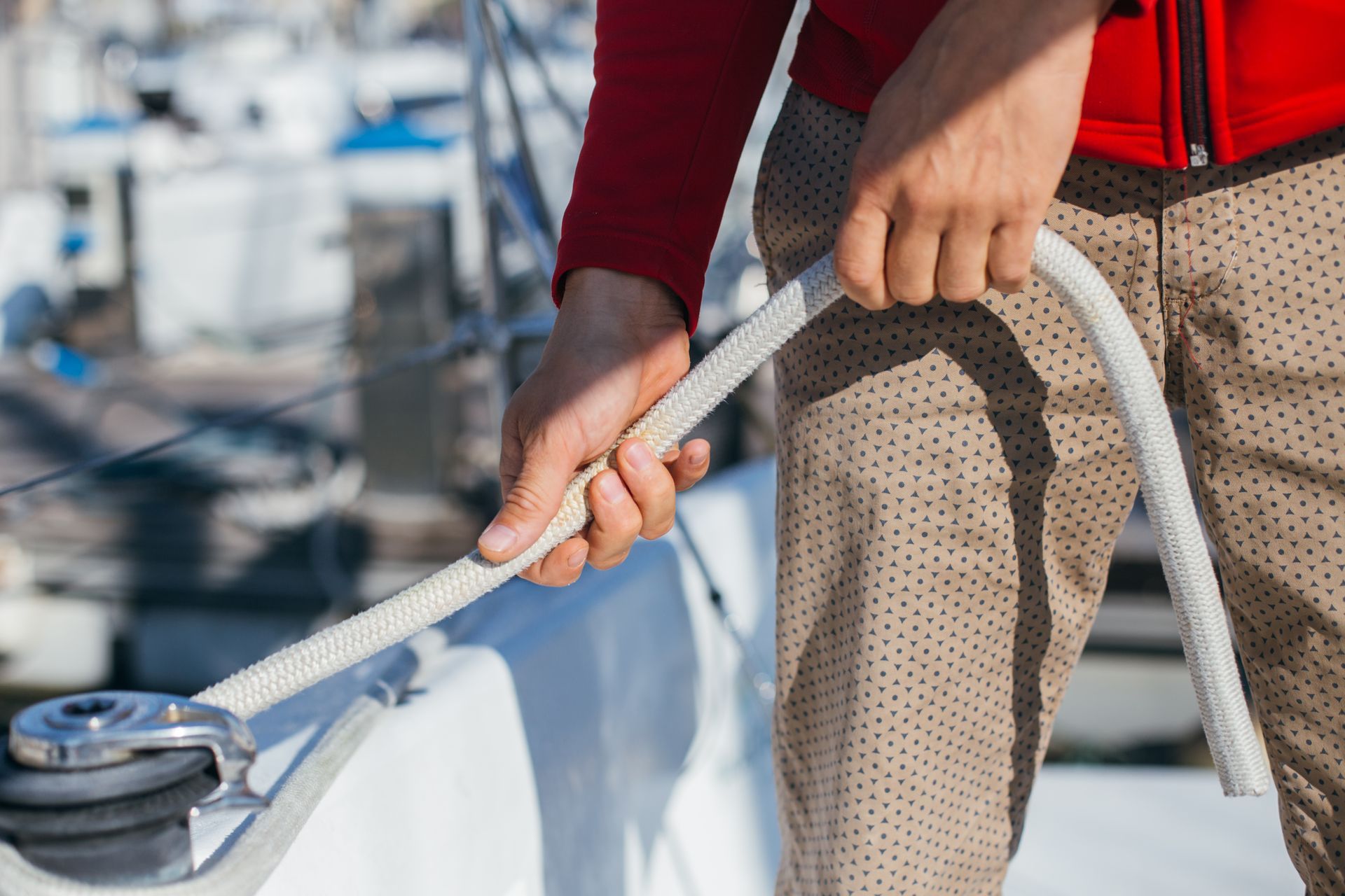 A person is holding a rope on a boat.