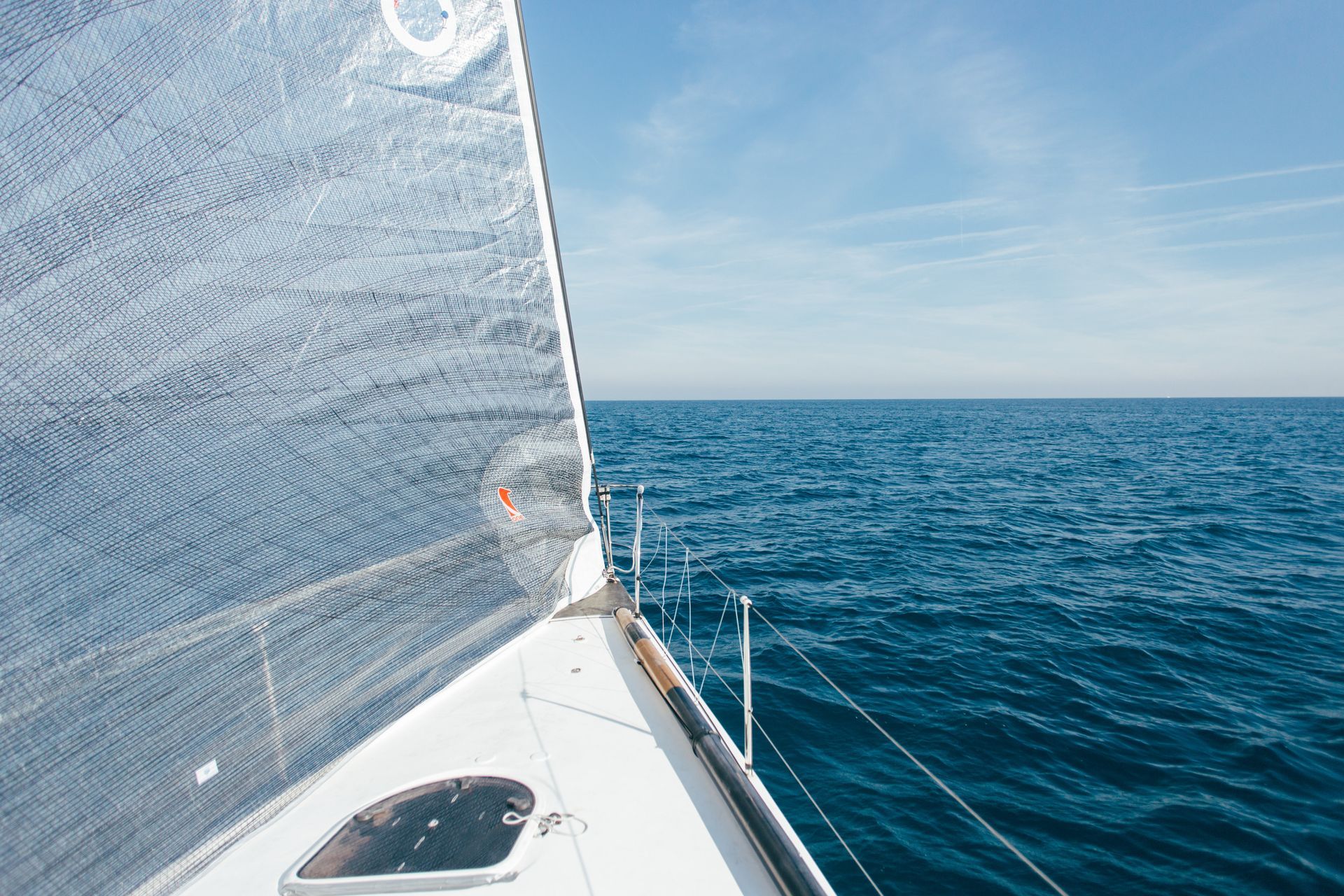 A sailboat is floating on top of a large body of water.