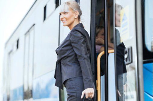 business woman getting down from bus