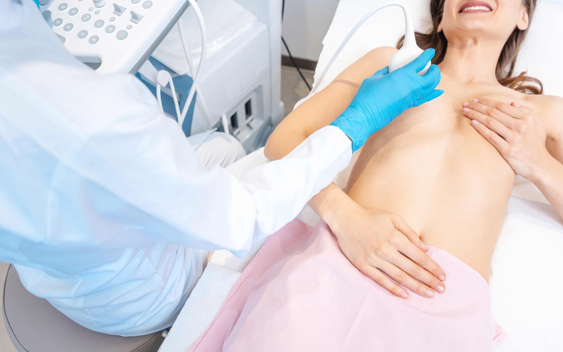 Medical ultrasound exam on a patient in a clinic, with a clinician using a probe on the neck. Medical ultrasound exam on a patient in a clinic, with a clinician using a probe on the neck.