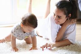 Mother Reading A Book To Her Baby Mother Reading A Book To Her Baby