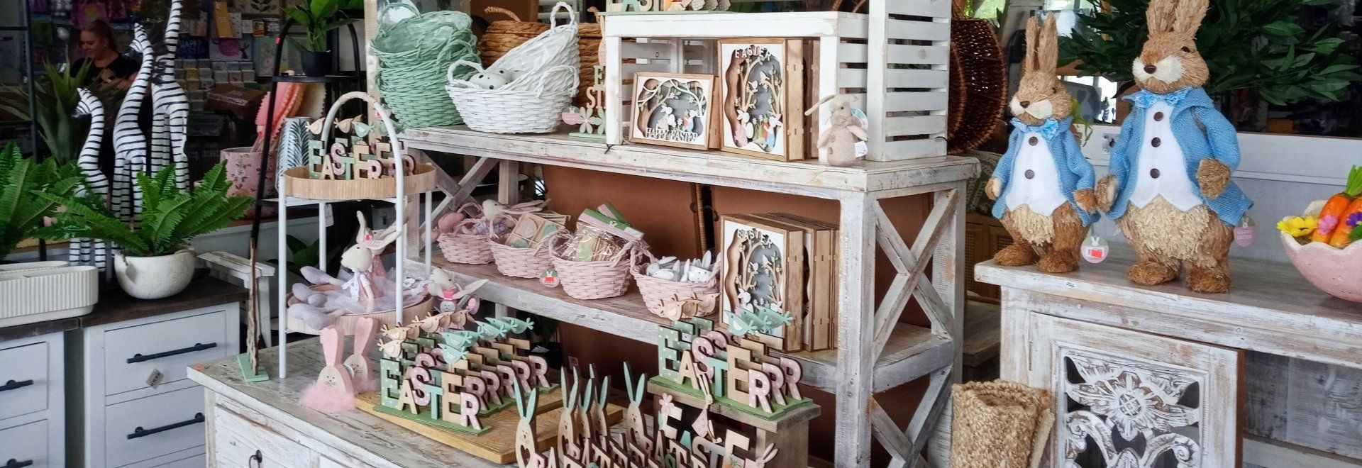 A shelf filled with lots of easter decorations in a store.