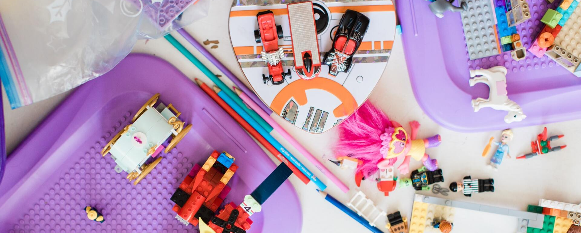 A table topped with a bunch of lego blocks and pencils.