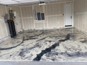 A garage with a marble floor and a door — San Leandro, CA — Mission Flooring and Countertop Design