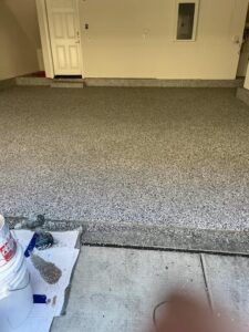 A garage floor is being painted in a house — San Leandro, CA — Mission Flooring and Countertop Design