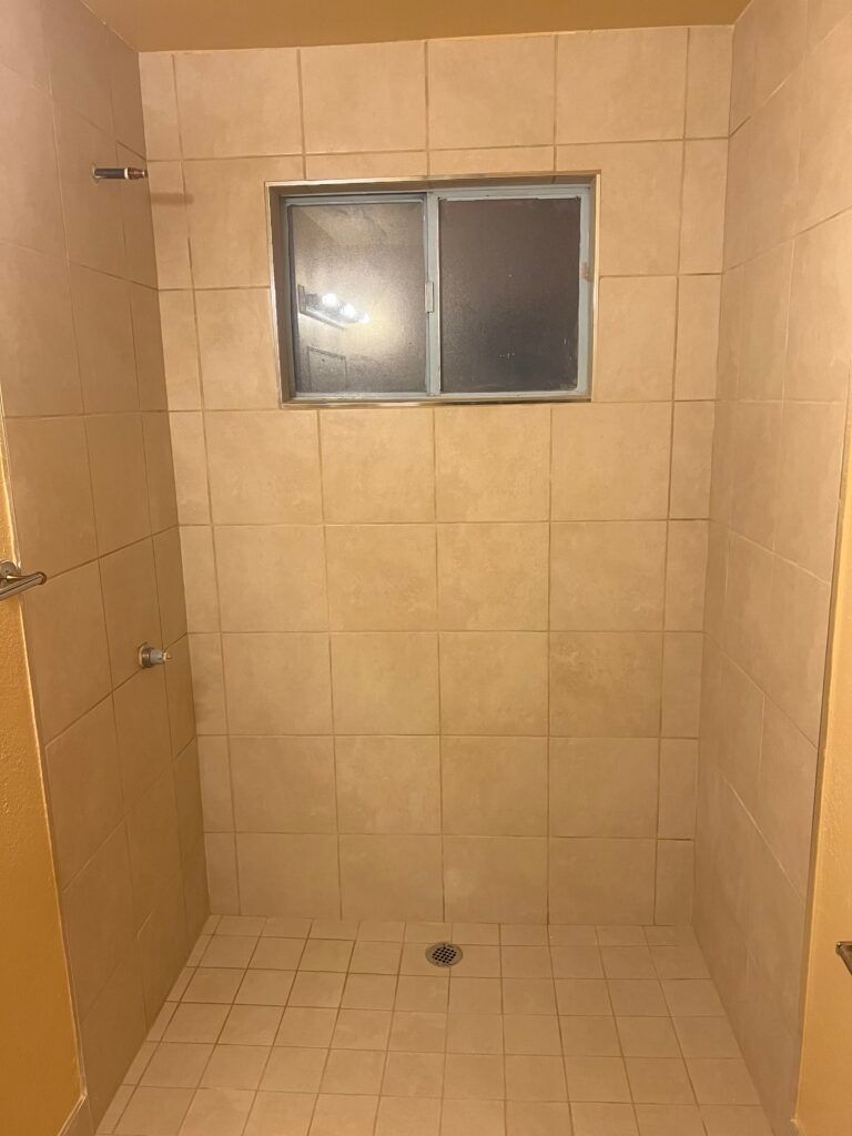 A bathroom with a shower and a window — San Leandro, CA — Mission Flooring and Countertop Design