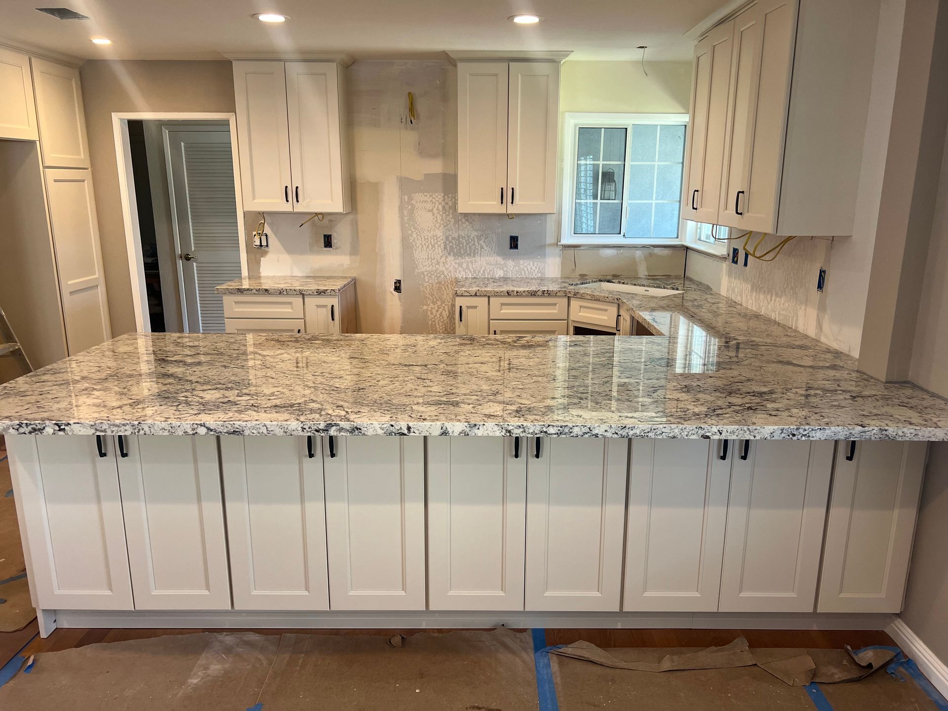 A kitchen with wooden cabinets and a black counter top — San Leandro, CA — Mission Flooring and Countertop Design