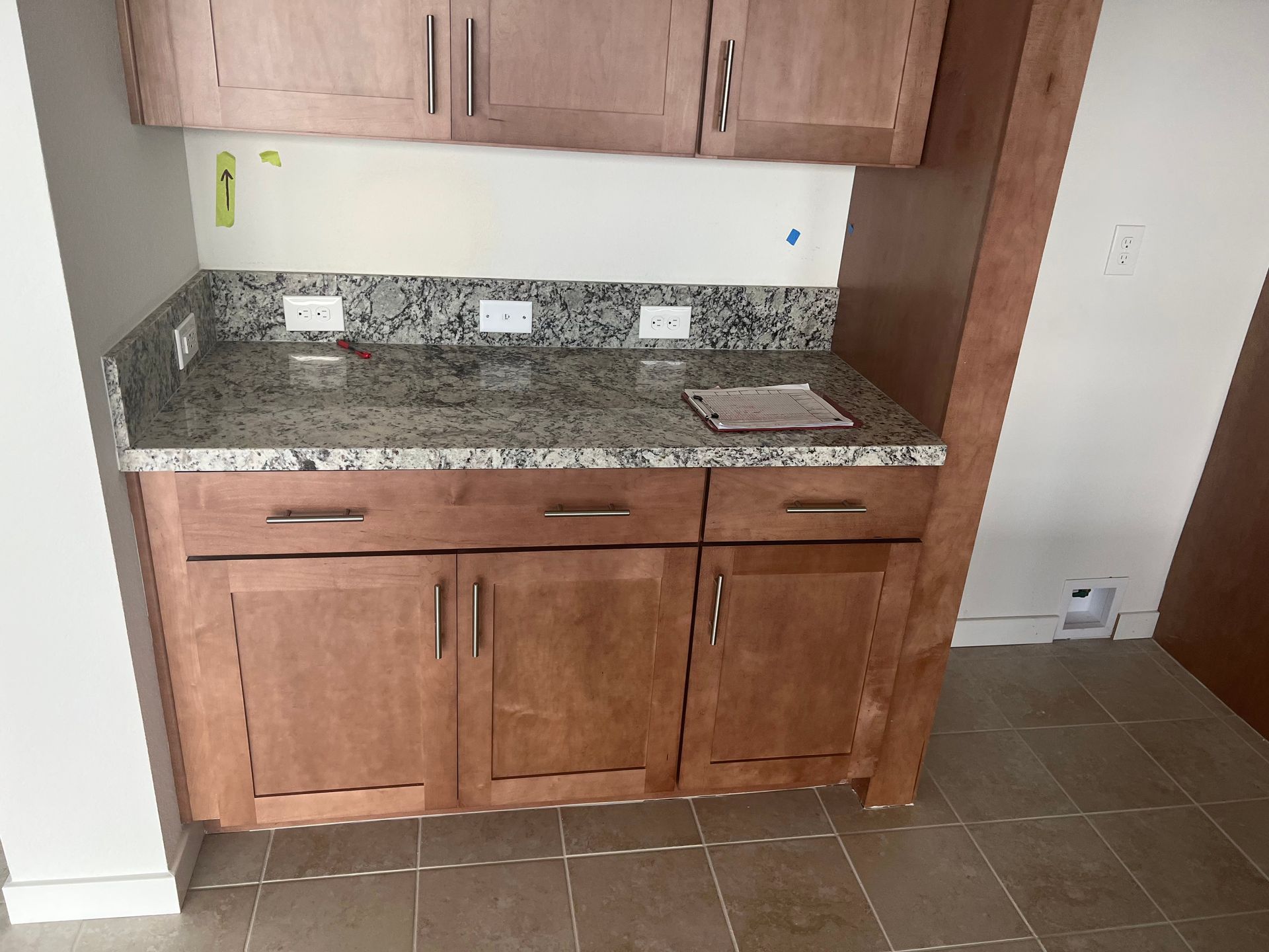 A kitchen with black cabinets and white counter tops — San Leandro, CA — Mission Flooring and Countertop Design
