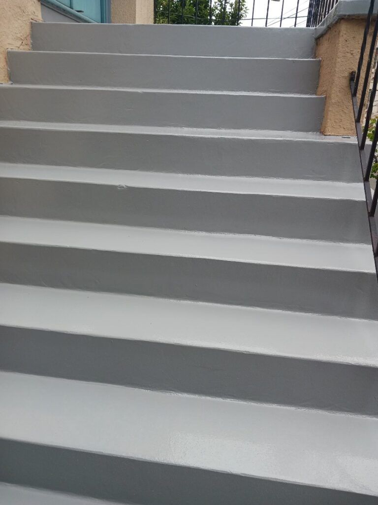 A set of stairs leading up to a building with a railing — San Leandro, CA — Mission Flooring and Countertop Design