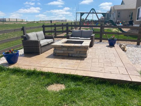 There is a fire pit in the middle of the backyard.