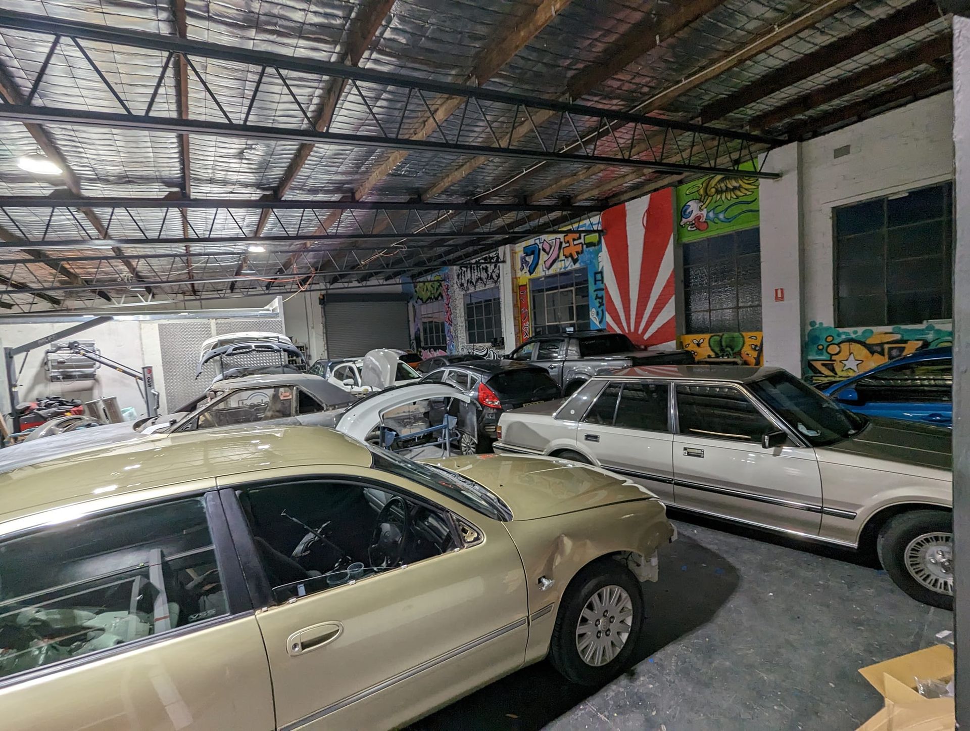 Inside an Auto Repair Shop, Various Cars Are Parked — Moto Bodyworks in Fyshwick, ACT