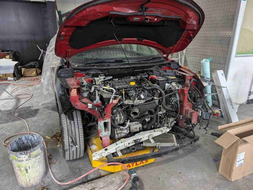 A Car Being Repaired at an Auto Shop With the Hood Open — Moto Bodyworks in Fyshwick, ACT