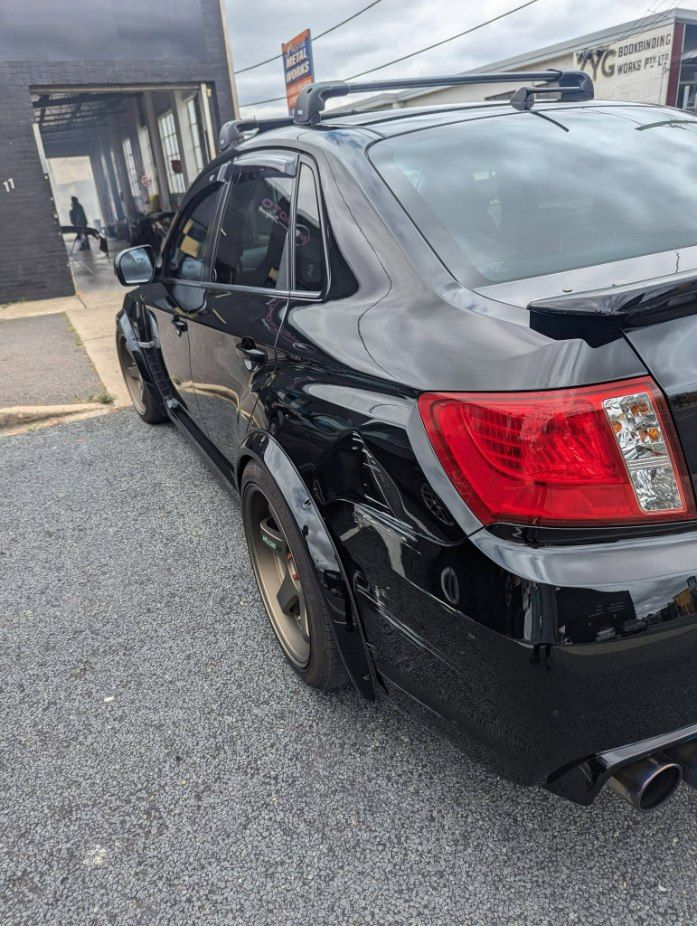 A Black Car is Parked in a Gravel — Moto Bodyworks in Fyshwick, ACT