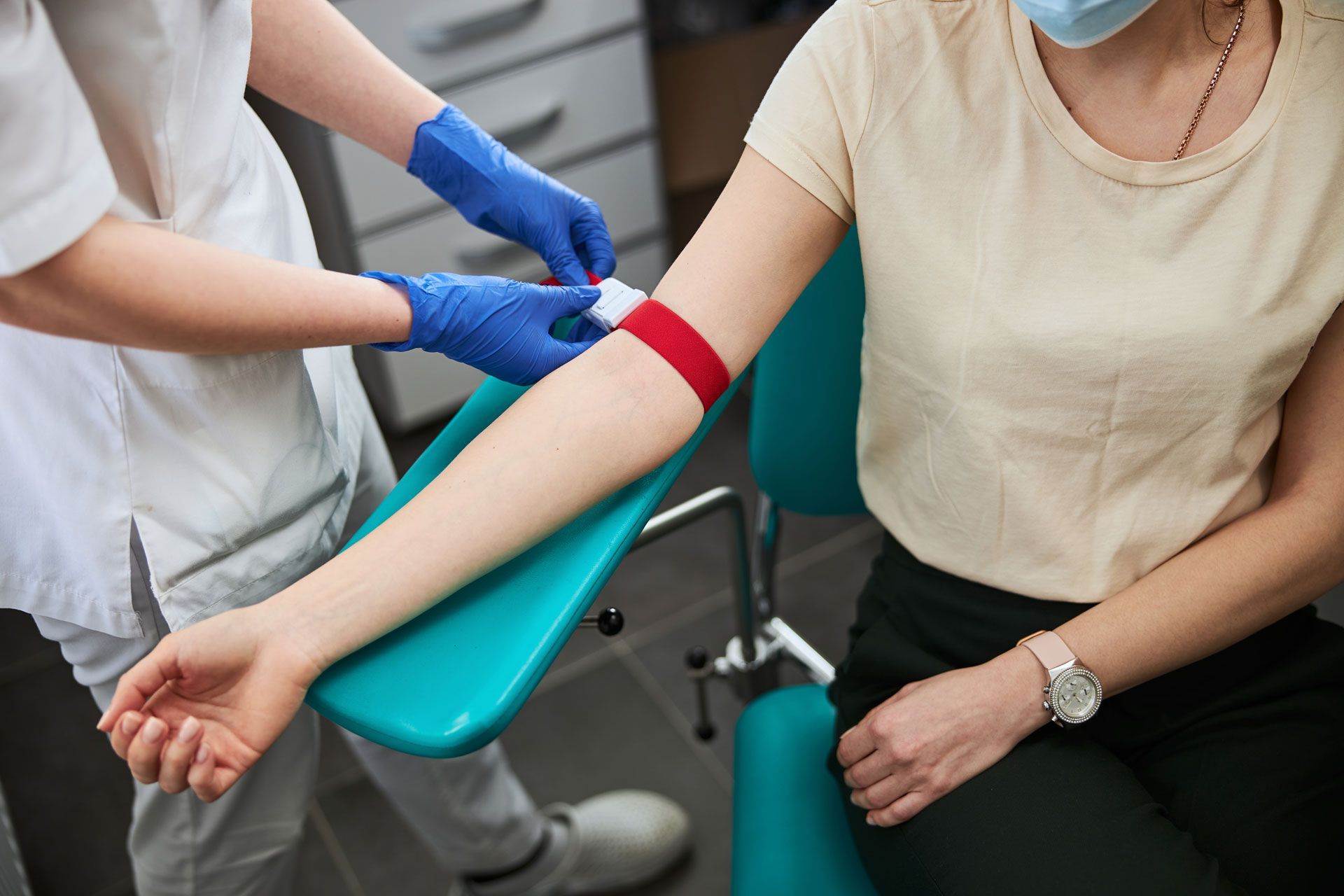 Phlebotomy Technician Tightening the Elastic Band