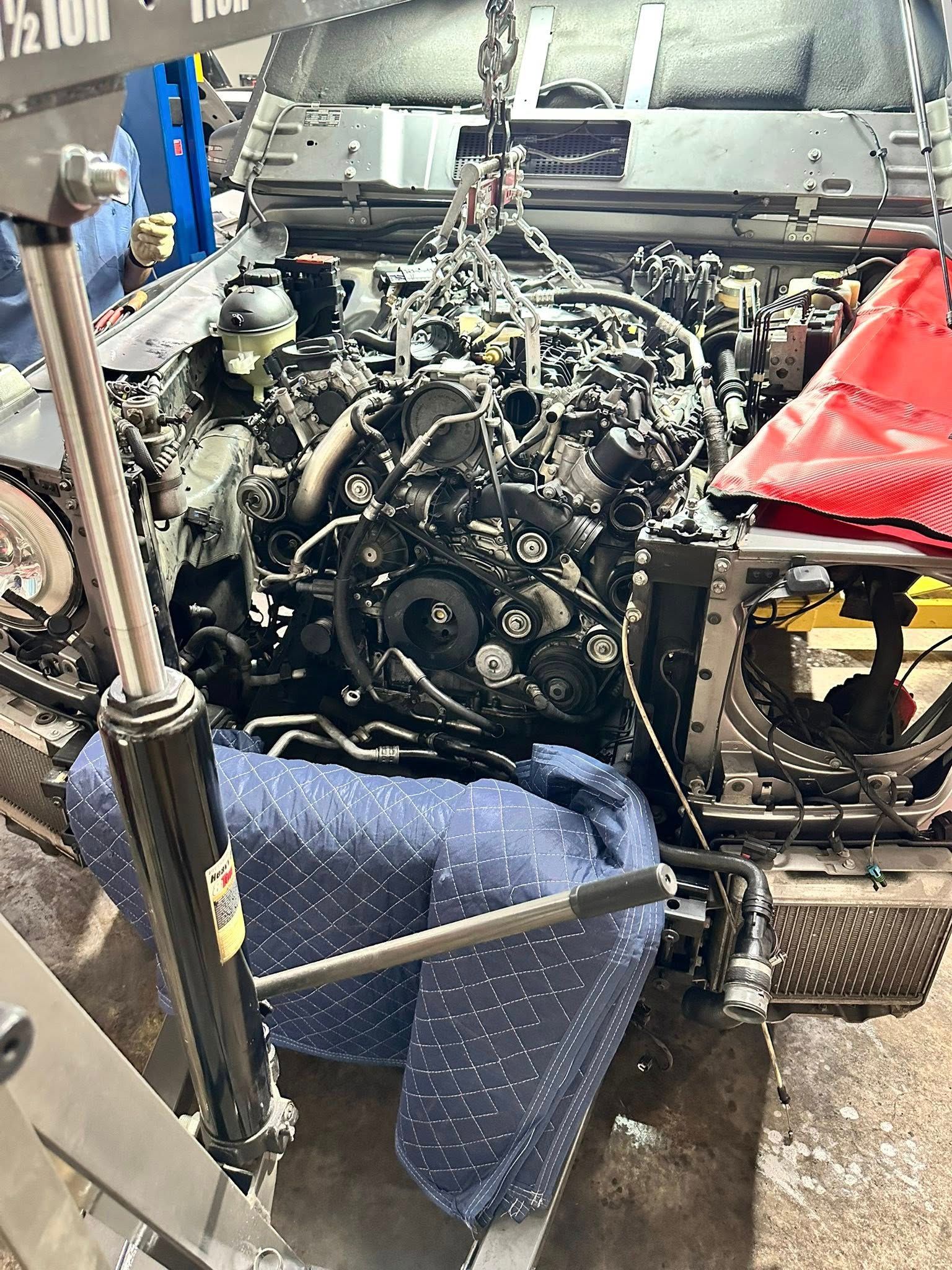 Technician Performing Detailed Engine Repair Inside Shop | UAC