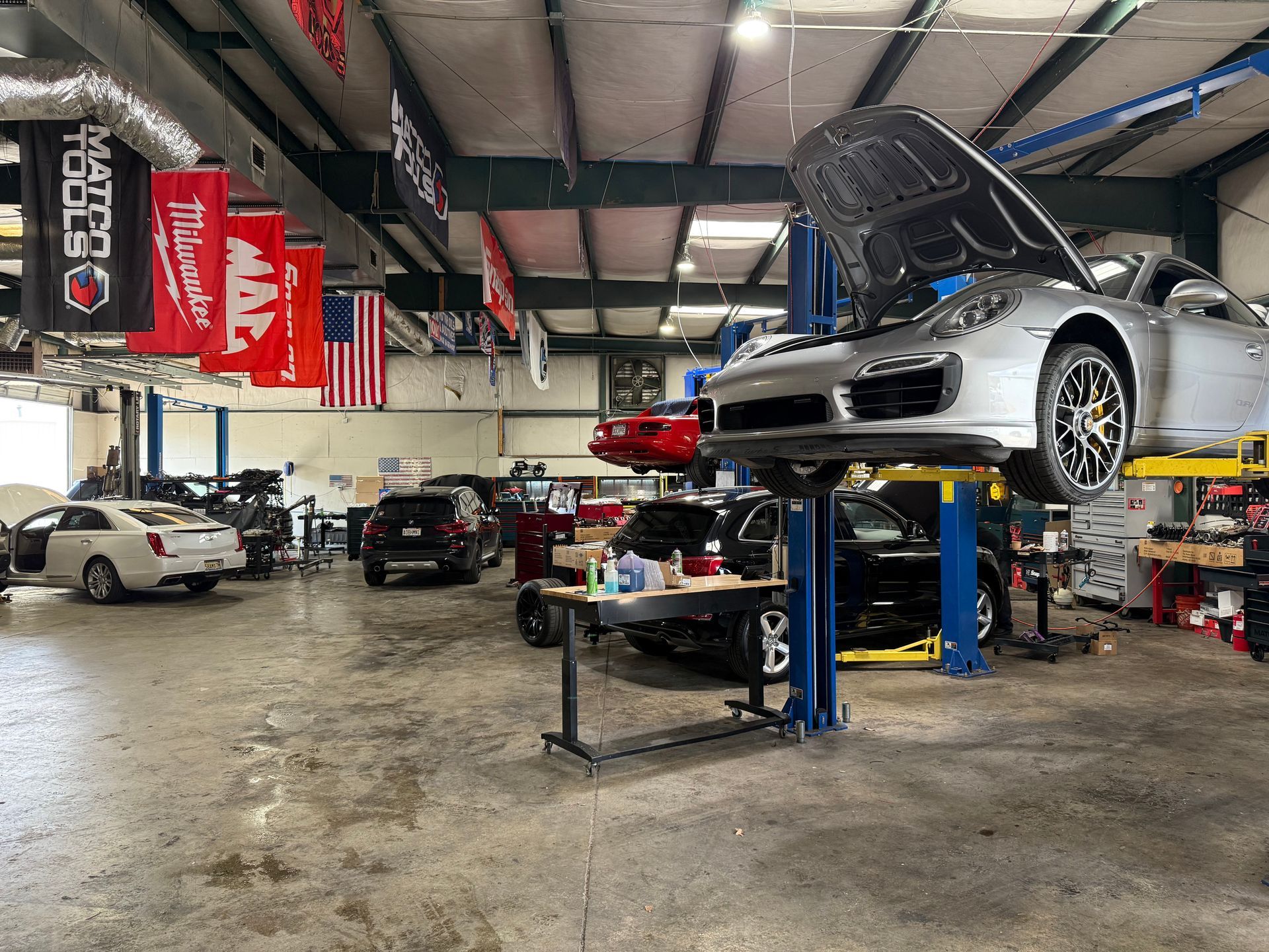 Multiple Vehicles Inside Professional Auto Repair Shop Bay | UAC