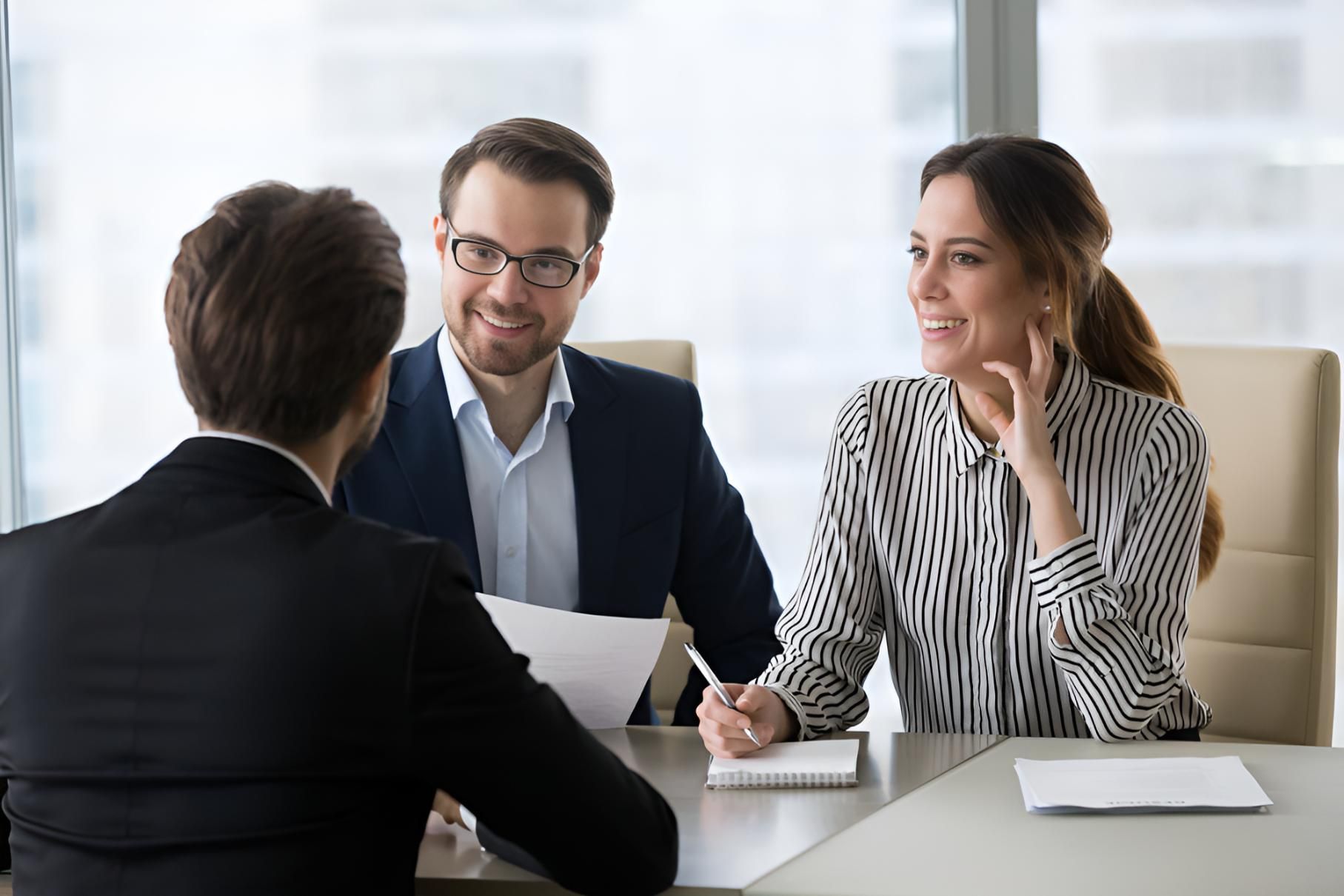 A man and a woman are sitting at a table having a job interview — Bee HR in Newcastle, NSW