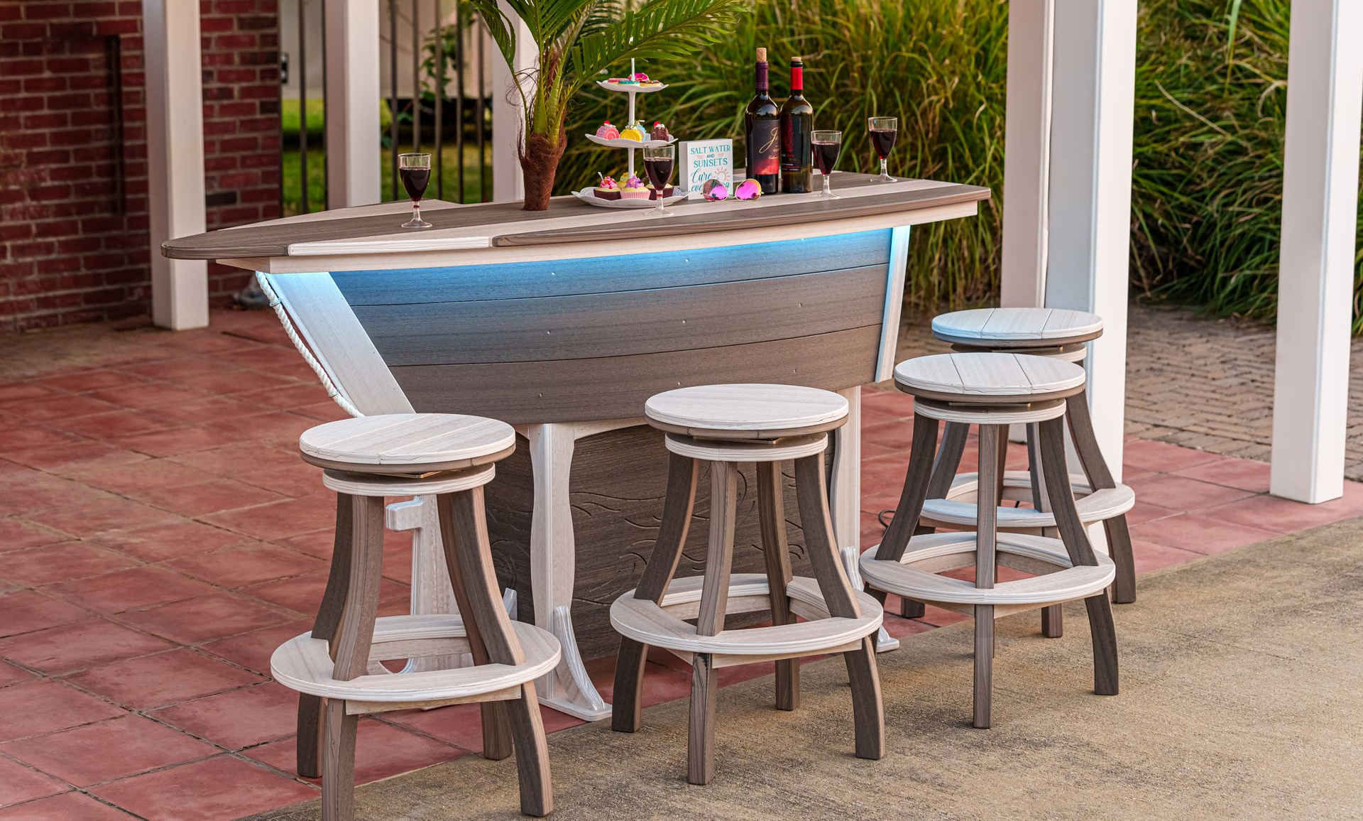 a wooden lighthouse is sitting on a sidewalk in front of a lake .