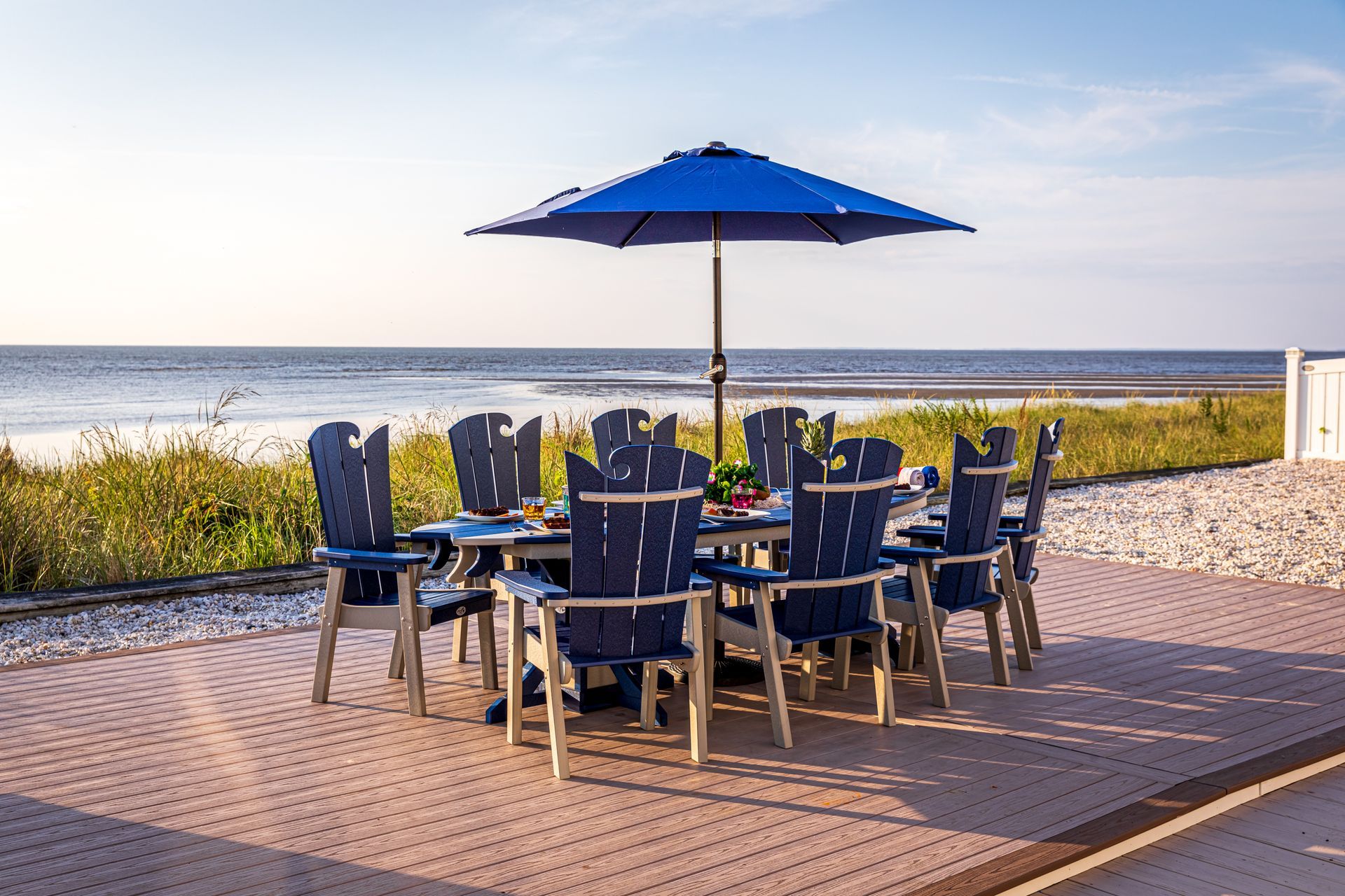 A table and chairs under an umbrella on the beach