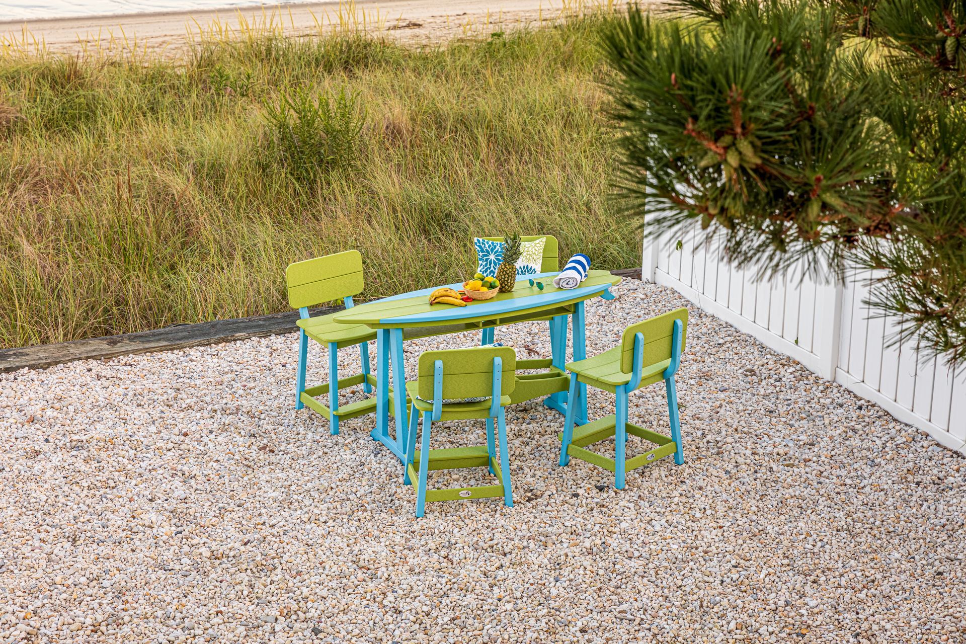 A children 's table and chairs set in a gravel area.