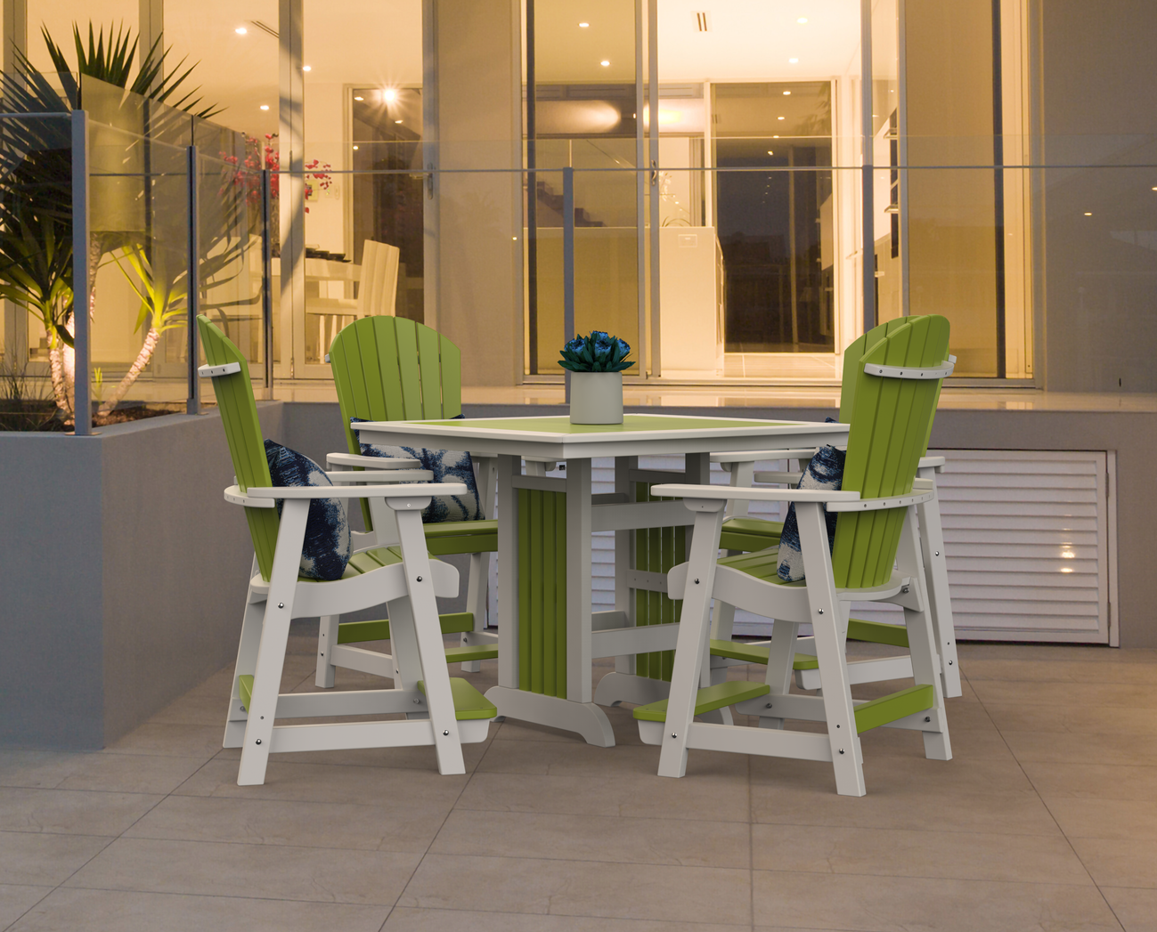 A wooden rocking chair is sitting on a patio next to a fire pit.