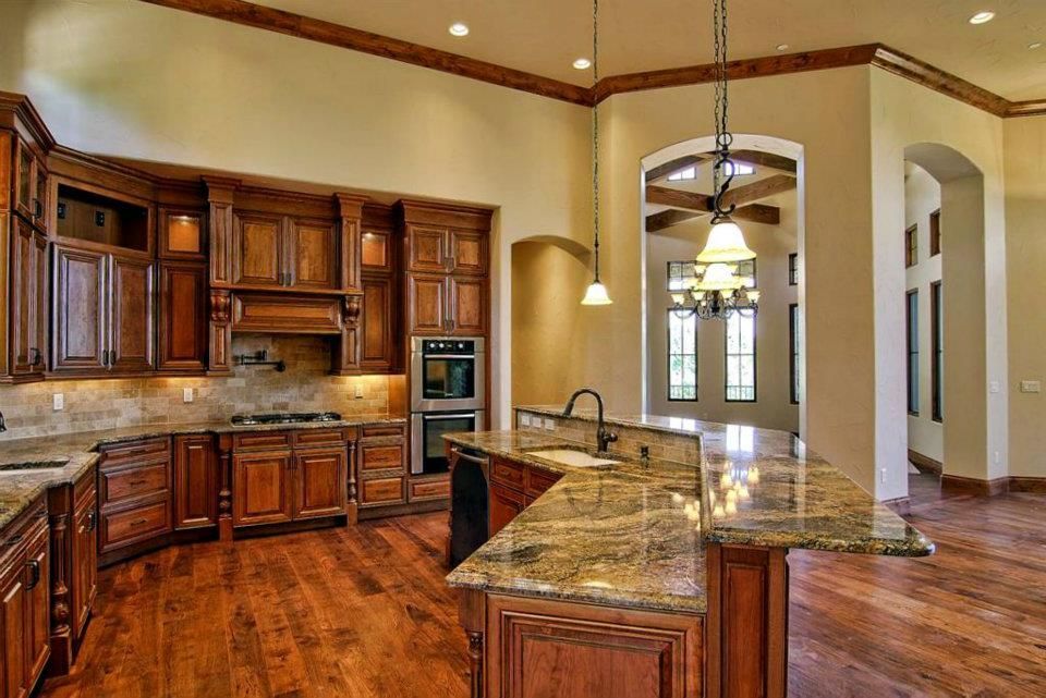 A kitchen with wooden cabinets and granite counter tops