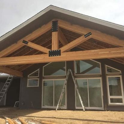 A house with a wooden roof and a ladder in front of it