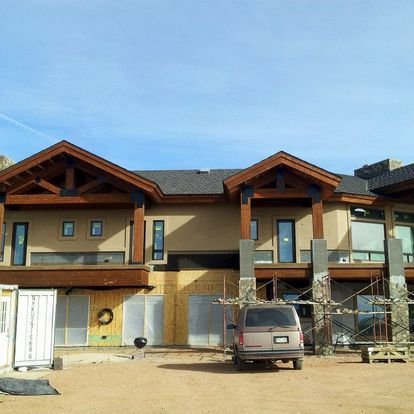 A van is parked in front of a building under construction