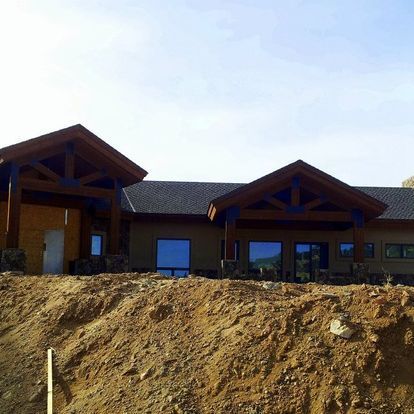 A house is being built on top of a dirt hill