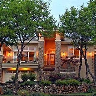 A large house with a lot of windows and trees in front of it.