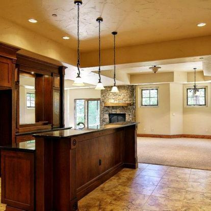 A kitchen with a large island and a fireplace