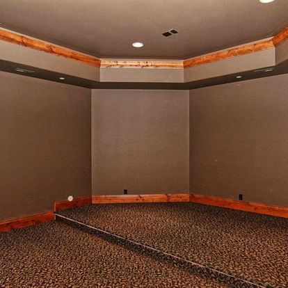 An empty room with a large mirror on the floor